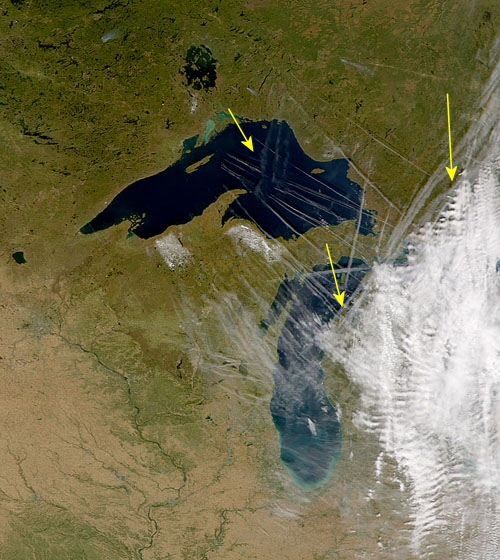 A nice true color image from NASA looking at the back edge of a storm that is just clearing the western Great Lakes states. This is a very dry atmospheric environment in that the passing storm has cleared the area of available moisture for clouds formation plus the inherent stabilization, post storm, leads to very clear skies. So we have many thick contrails that are lasting in an environment that shouldn’t support their visible existence. Hence we have evidence of the contrail markers versus natural contrails. Abundant rippling over Michigan tells us that we have EM energies stimulating the atmosphere and thus the weather makers need to fly the contrails to measure this action and decide whether to employ counter measures as needed. A couple of arrows have been added to point out the thick spreading contrails laid down just along the back edge of this storm, and the interesting dissipation over central Lake Superior marked earlier by the fading three north/south contrails. End the scalar/EM warfare; end the contrail marker program.